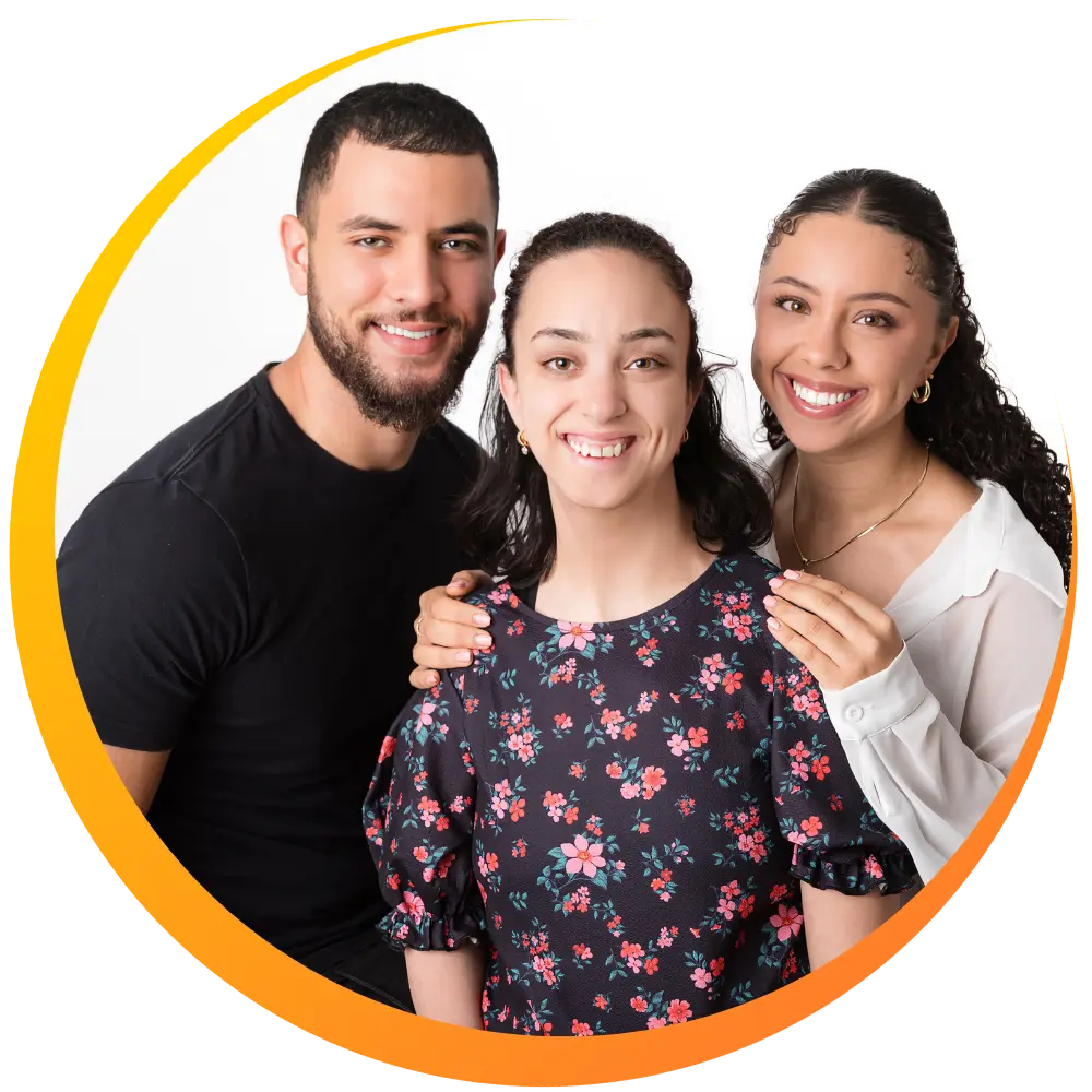 A disabled woman smiling with two her siblings