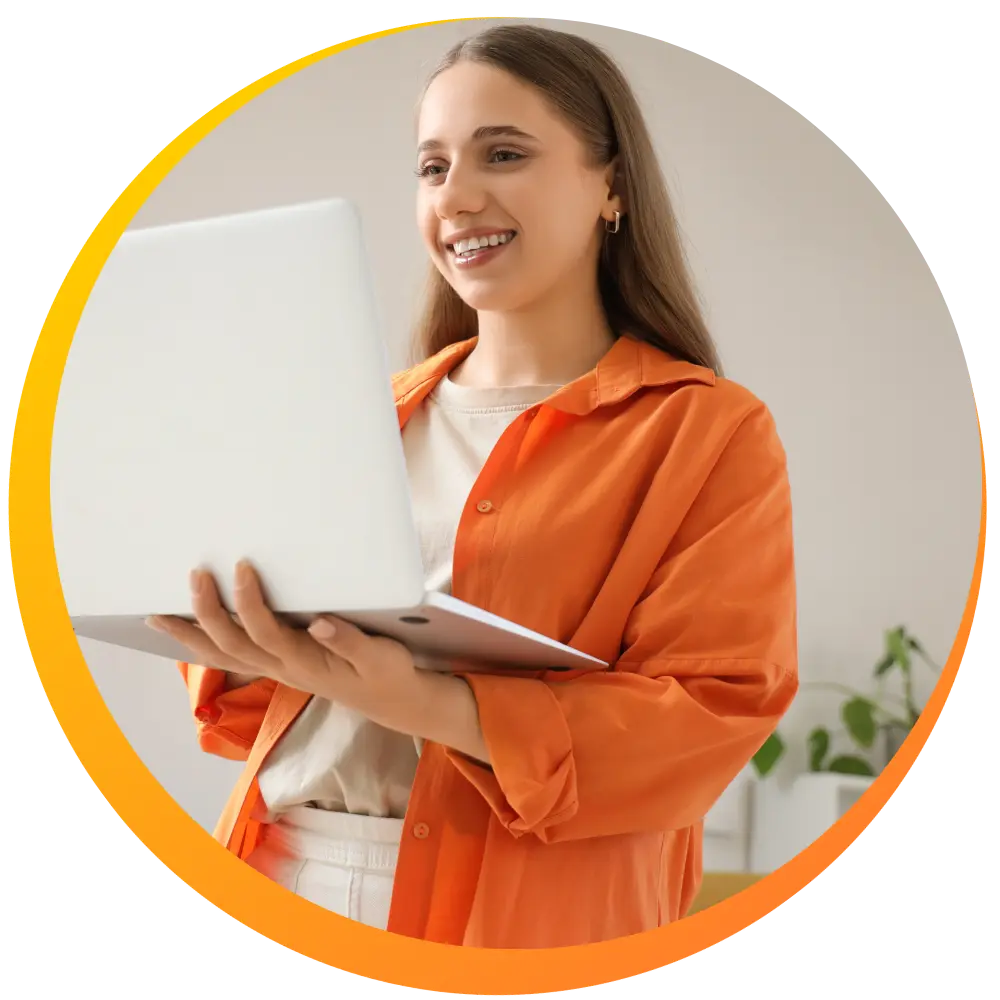 A woman smiling while holding her laptop and making an NDIS referral