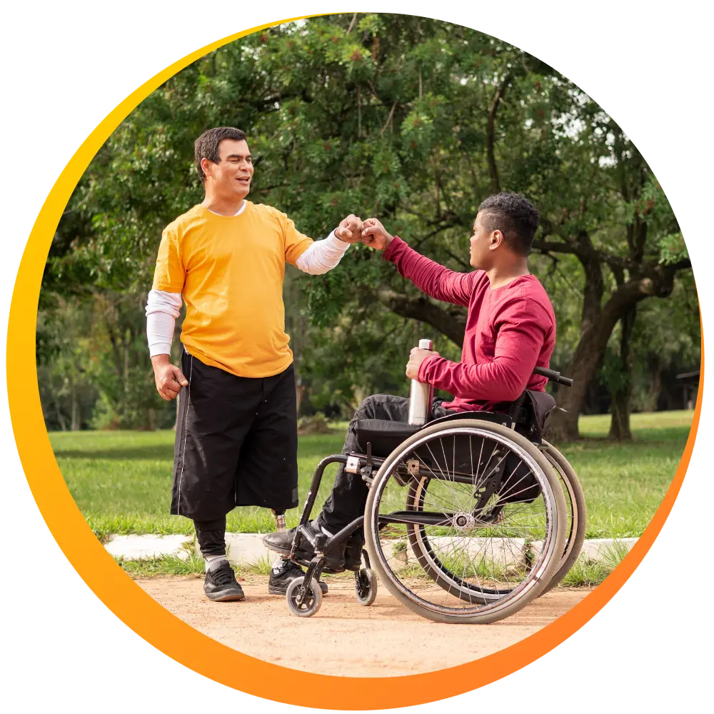 A disabled man sitting in his wheelchair and another disabled man fist bumping